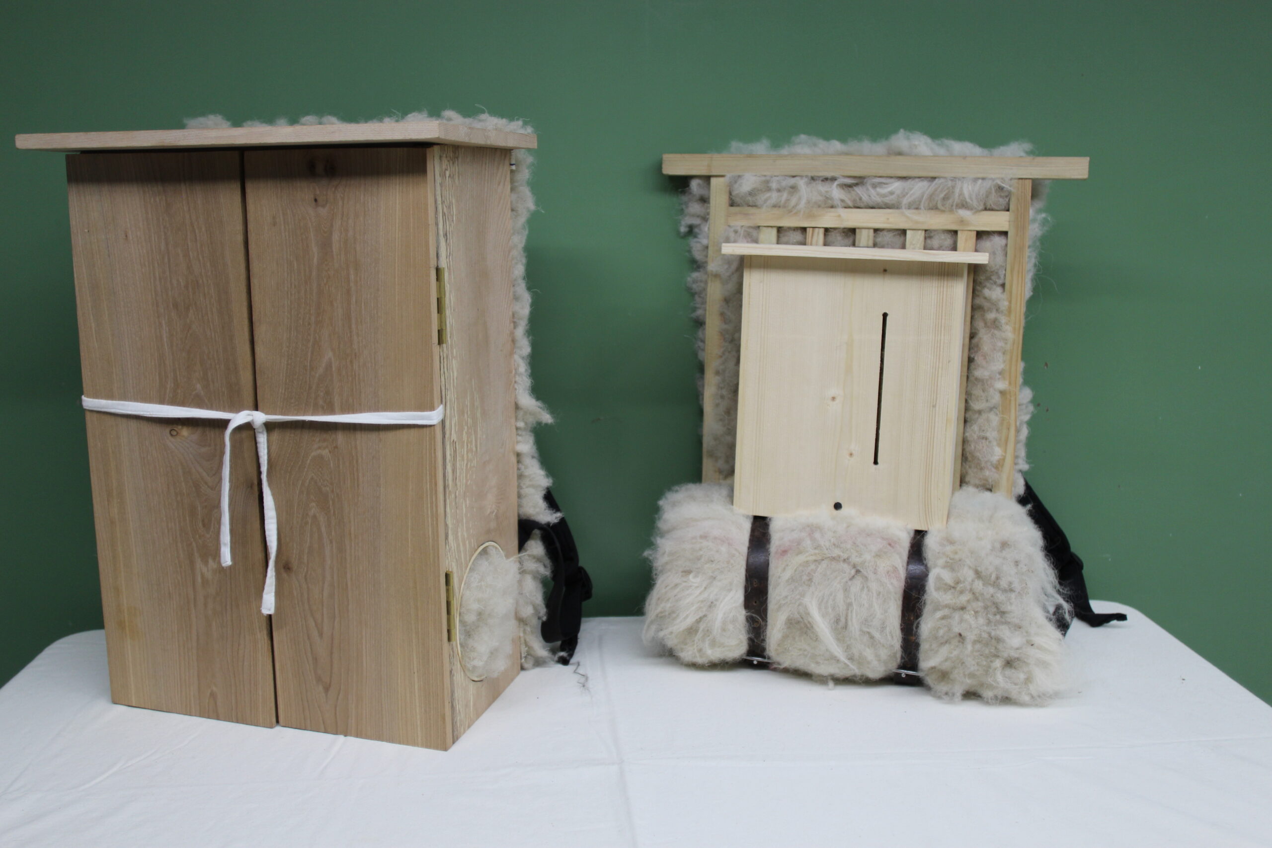 The two HAKOTO instruments: wooden backpack boxes lined with fleece